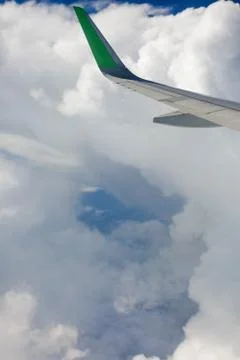 View from the airplane window to the sky in the clouds, vertical orientation Stock Photos