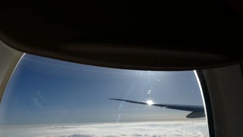 View from airplane window sky sunshine clouds Stock Footage 98615209