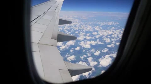 View From Airplane Window Soaring Through Fluffy White Clouds at High Altitude Stock Footage 301913009