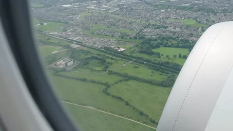 View from an airplane window on a sunny day showing green landscape as the Stock-Footage 311769169