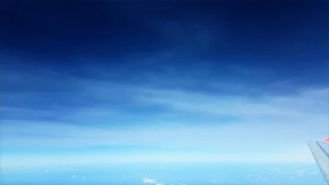 View from an airplane window on a sunny with smooth blue sky Stock Footage 74953826