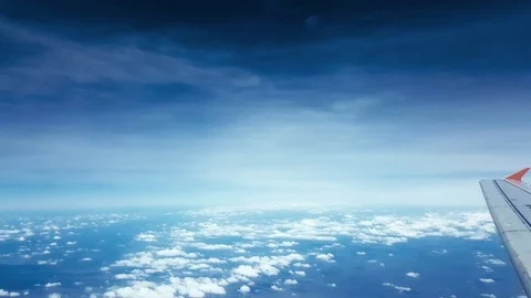 View from an airplane window on a sunny with smooth blue sky Stock Footage 74954702
