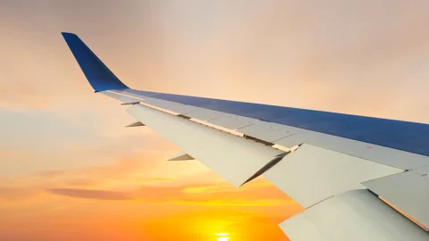 View from a airplane window to a sunset time lapse scene Stock Footage 297757457