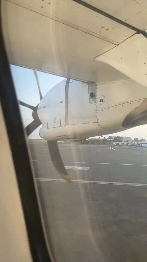 View from airplane window of turboprop engine on runway return flight Stock Footage 344040831