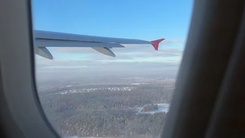View from airplane window of Vilnius covered with snow in winter on sunny day Stock Footage 262365284