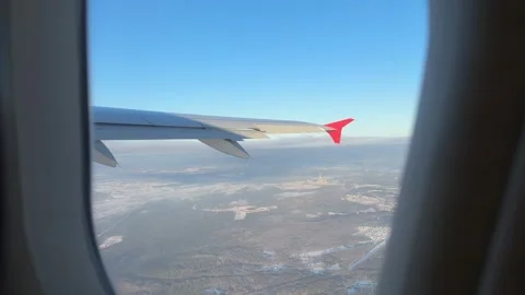 View from airplane window of Vilnius covered with snow in winter on sunny day Stock Footage 262365287