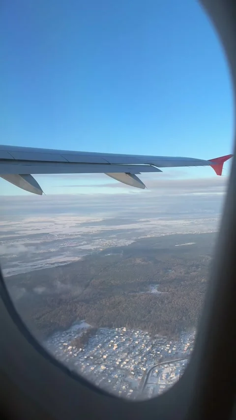 View from airplane window of Vilnius covered with snow in winter. Vertical Stock Footage 262365288