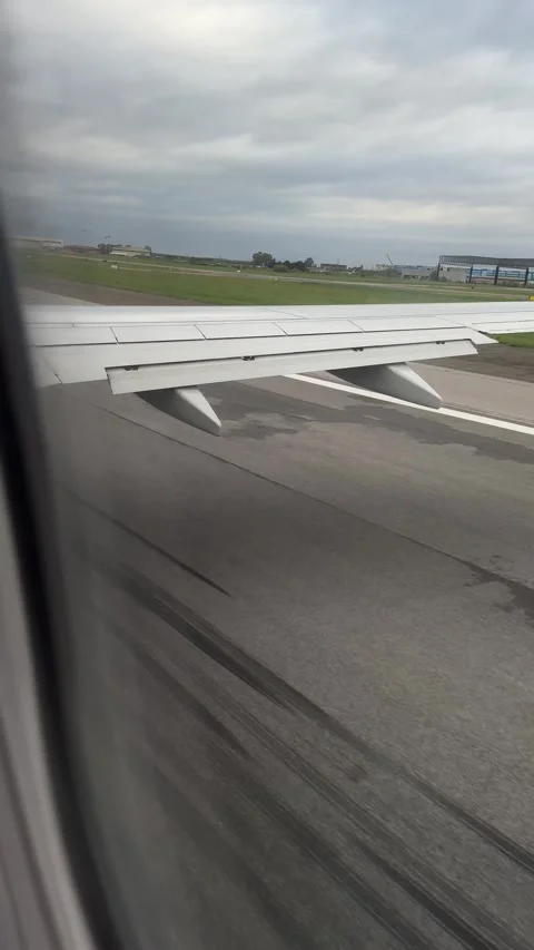 View from airplane window while taxiing on runway at Pisa airport Stock Footage 306959864
