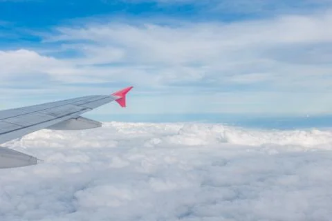View from airplane window with white cloud and blue sky Foto stock