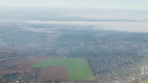 View from the airplane window on white clouds and Polish territory. Stock Footage 308189885