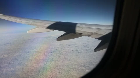 View From Airplane Window Of Wing Above Clouds Left To Right Video stock 102501196