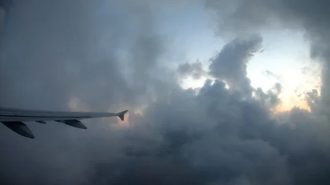 View from airplane window. Wing of an airplane flying above the clouds with Stock Footage 103676219