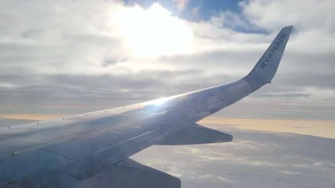 The view from the airplane window. Wing of an airplane flying above the blue  Stock Footage 168376333
