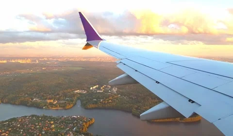 View From Airplane Window. Wing Of Airplane Flying Above The Clouds. Stock Footage 243372928