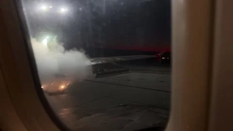 View from airplane window of the wing being sprayed with deicing fluid Stock Footage 262365052