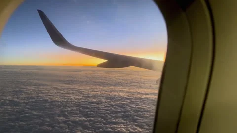 View from an airplane window: the wing extends over a sea of clouds. Stock Footage 319405654