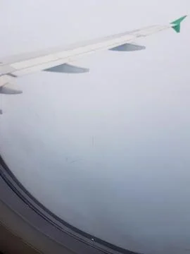 View from airplane window on the wing when departure. Stock Photos