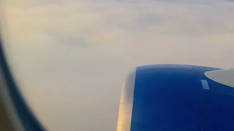 View of an airplane wing,. Airplane wing scenic calmly flying above soft white  Stock Footage 320056807