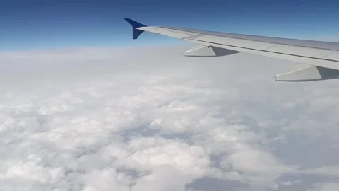 The view of the airplane wing and clouds from the plane window Stock Footage 282237026