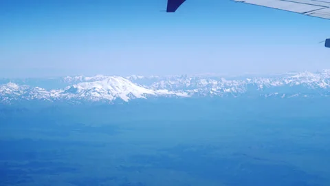 View of an airplane wing from the inside, flying over mountains. Stock Footage 246879631