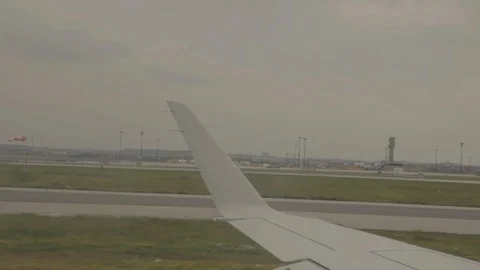 View of Airplane Wing Outside of Window On Runway Stock Footage 100836149