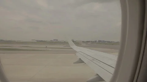View of Airplane Wing Outside of Window On Runway Stock Footage 100838429