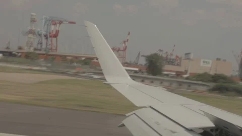 View of Airplane Wing Outside of Window On Runway Video stock 100838455