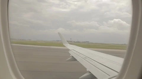 View of Airplane Wing Outside of Window On Runway Taking Off Stock Footage 100838821