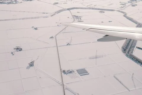 View of an airplane wing with snows on land Stock Photos