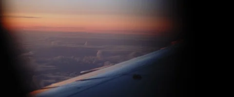 View of an airplane wing at sunset during the flight Stock Footage 127136357