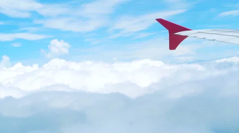 View of airplane wing through plane window, airplane flying into the clouds 스톡 동영상 52849560