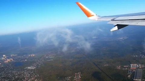 View of an airplane wing from the window against the backdrop of a cloudy sky Stock Footage 167646689