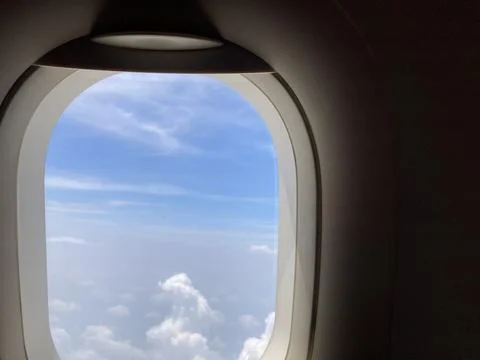 View from an airplane’s shade seeing the cloudscape Stock Photos