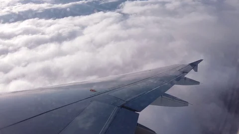 View of the airplanes wing and the clouds out of airplanes window Video stock 105455091