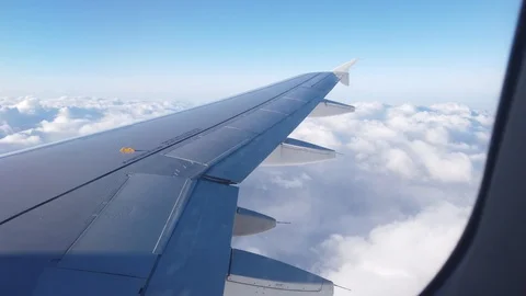 View of the airplanes wing and the clouds out of airplanes window Video stock 105455243
