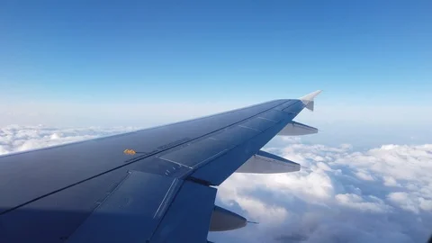 View of the airplanes wing and the clouds out of airplanes window 스톡 동영상 105455477