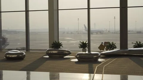 View of the airport airside area through giant window of domestic terminal .. Video stock 341848178