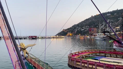 A view of Alanya pier in the evening during sunset showing the lighthouse and pa Stock Footage 297416007