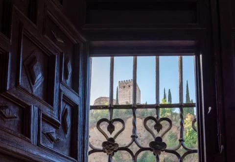 View of the Alhambra behind the bars of a window Stock Photos