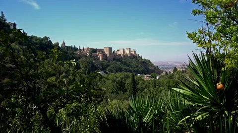 View of the Alhambra palace through greenery.  Granada, Spain. Видео 55708783