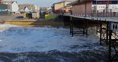 View along Blackpool Pier towards the shore. The waves have been Stock Footage 125845920