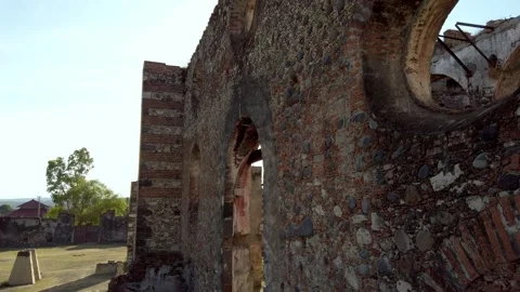 View Along Weathered Stone Wall of Historic Hacienda Ruins with Arched Openings Stock Footage 338413648