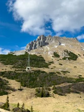 View of an alpine mountain range against a background of blue sky and clouds Stock Photos