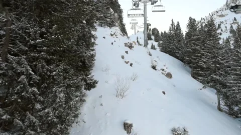 View of an alpine mountain slope while traveling on chairlift Stock Footage 194945460
