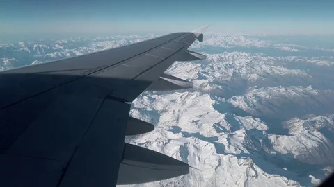 View of Alps and the plain wing from the airplane window Video stock 105456789