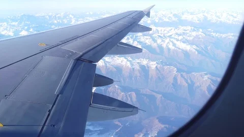 View of Alps and the plain wing from the airplane window Video stock 105463102