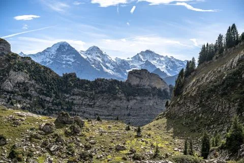 View into alps eiger monch and jungfrau summer daytime grindelwald Stock Photos