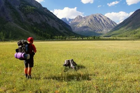 View from Altay range - Man with backpack on meadow - Karagem valley - Russia Stock Photos