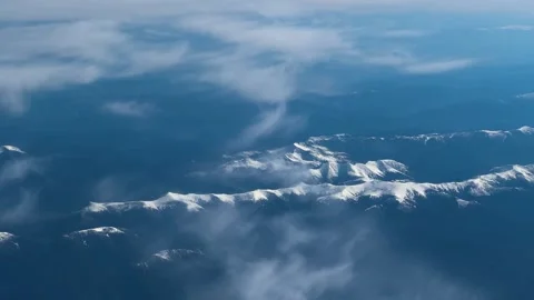 View of amazing snow capped mountain range from airplane window Stock Footage 338099746