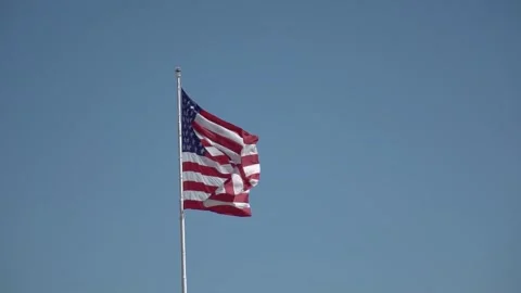 View of American flag on blue building background Stock Footage 254545104